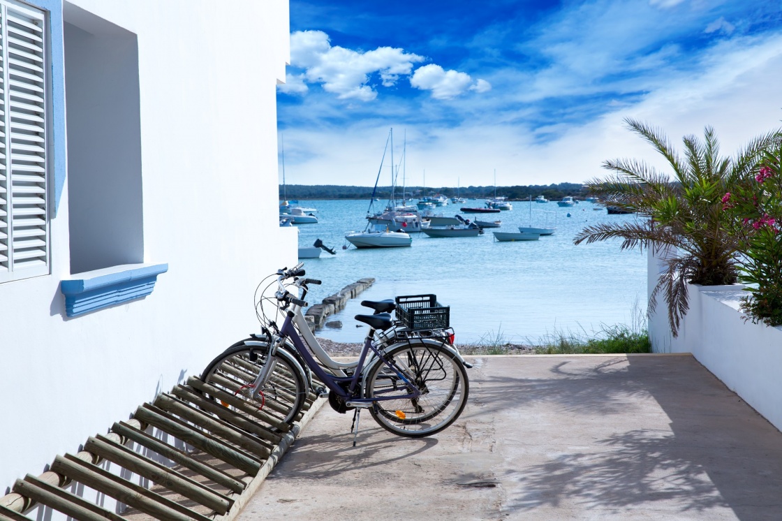 'Estany des Peix in formentera with bicycles parking lot and white Mediterranean houses' - Formentera